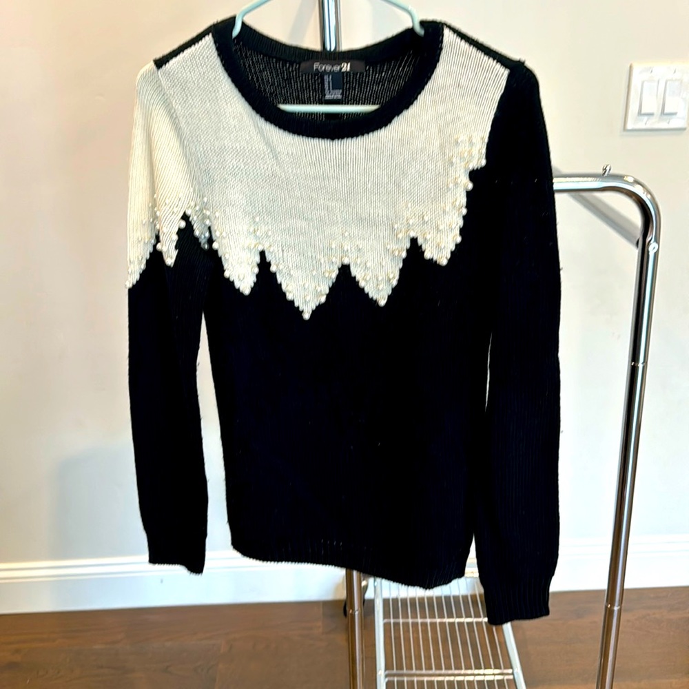 Cute long sleeve sweater with Pearl detail.